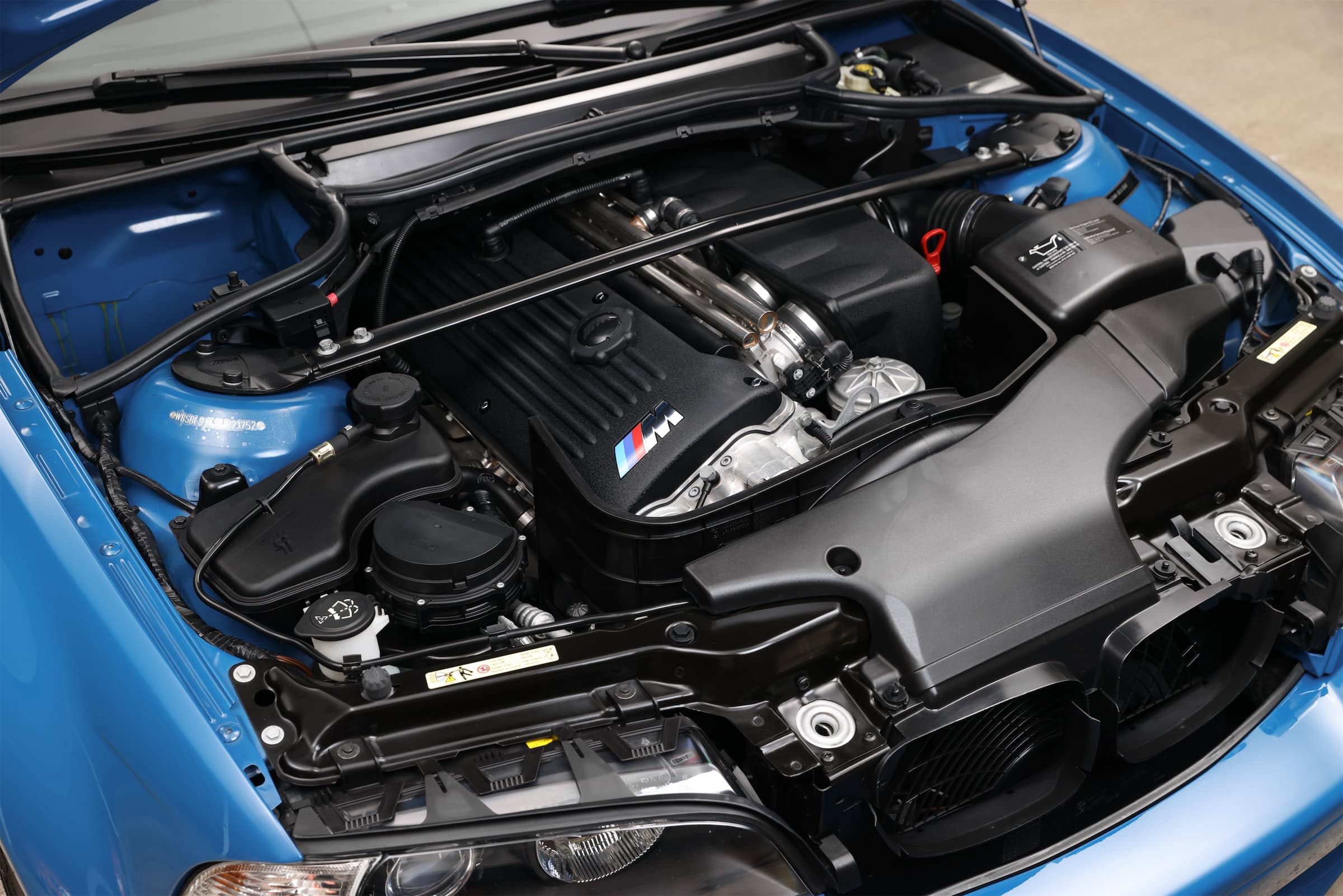 BMW M3 engine bay with individual throttle bodies